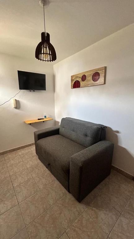 a couch sitting in a living room with a table at 760 C Apartamentos in Alta Gracia