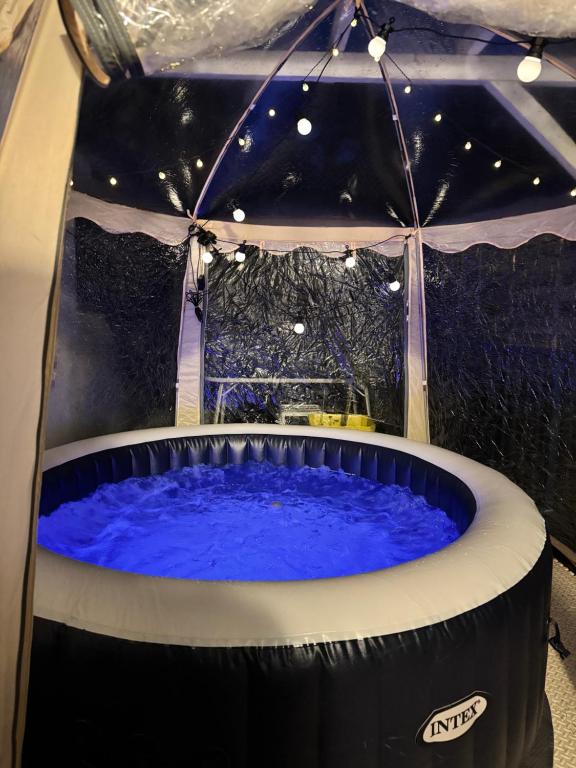 a large hot tub in a tent with lights at Duplex Trespoey - SPA - Place de parking in Pau
