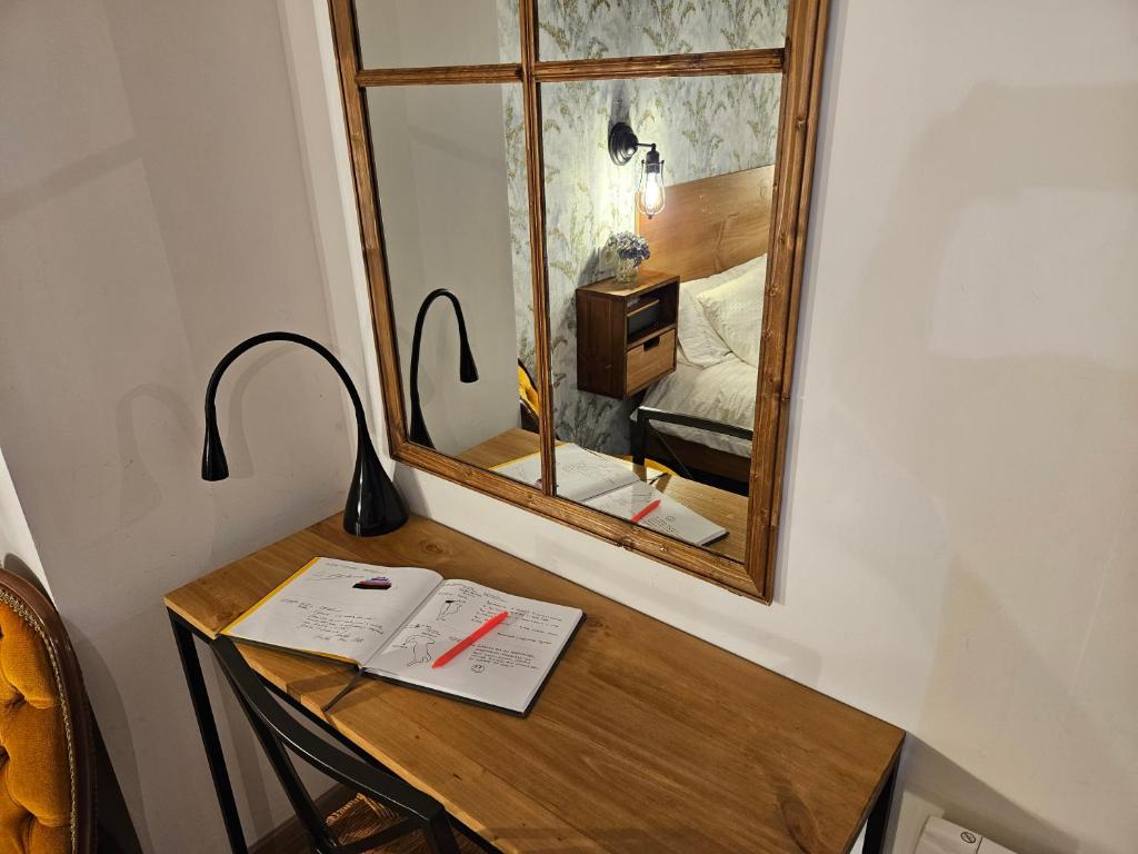 a table with a mirror and a lamp on it at URBAN LOFT VALENCIA in Valencia
