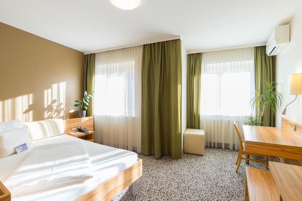 Voodi või voodid majutusasutuse Hotel Süd Graz toas