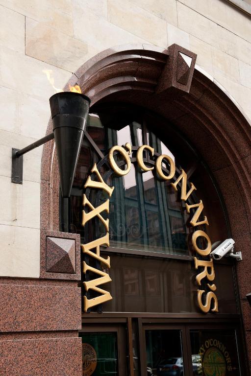 a sign for a store on the side of a building at Carlton George Hotel in Glasgow