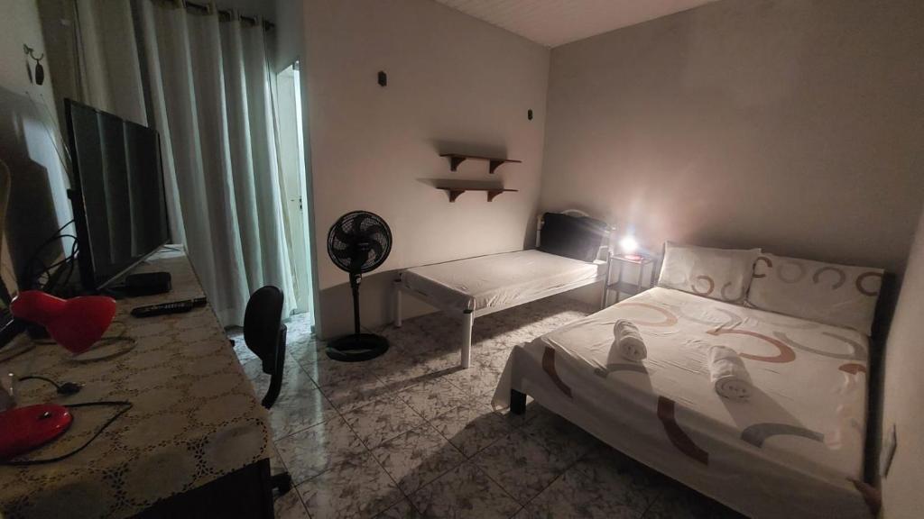 Postel nebo postele na pokoji v ubytování Will's House Hospedagem Familiar