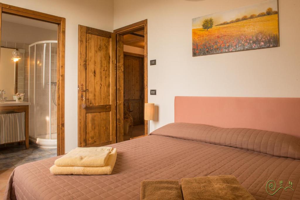 Łóżko lub łóżka w pokoju w obiekcie Locanda Camera con Vista