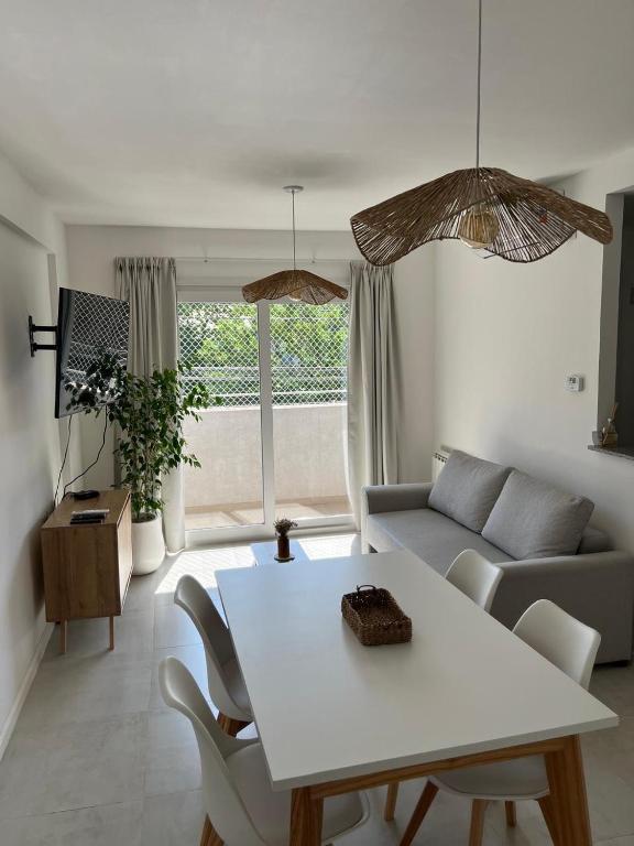 a living room with a table and a couch at Departamento Céntrico Álamos in Santa Rosa