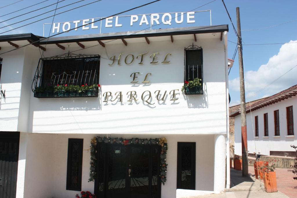 a white building with a sign that reads hotel be aware at Hotel El Parque HR in Fómeque