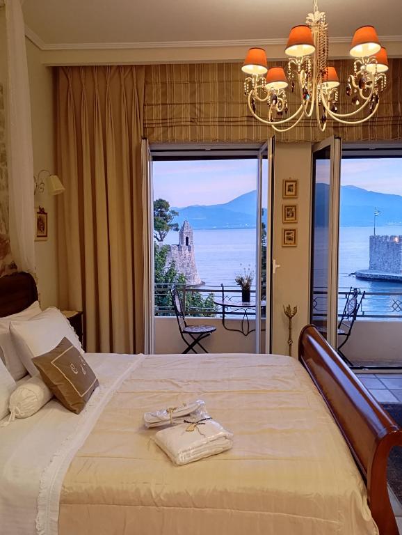 a bedroom with a bed with a view of the ocean at Casa da Sogno Elegant Studio in Nafpaktos