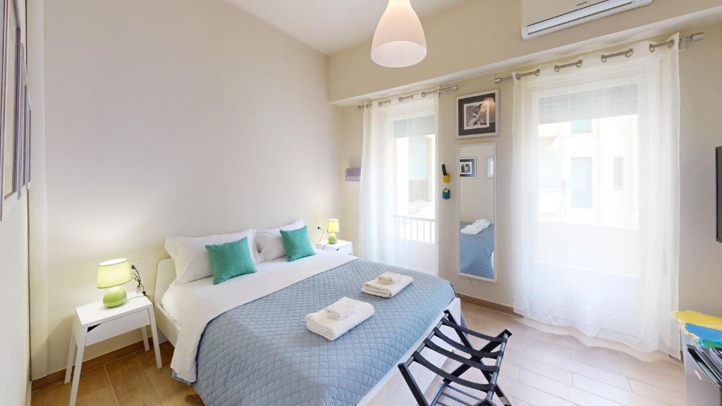 a bedroom with a bed with towels on it at Apartment Sonnino 37 in Cagliari
