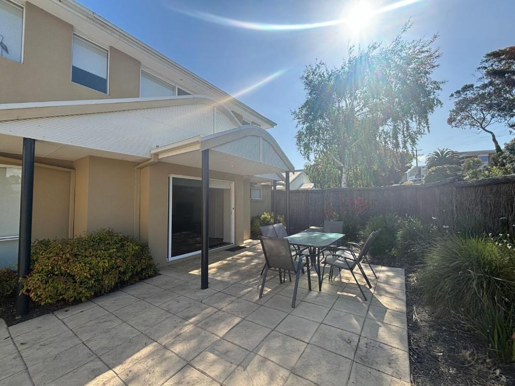 a patio with a table and chairs and a fence at Sandpiper 10 - Close to Town and Beach in Inverloch
