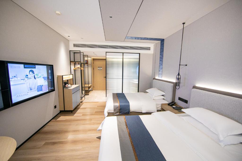 Postel nebo postele na pokoji v ubytování Chaozhou Yuyu Hotel