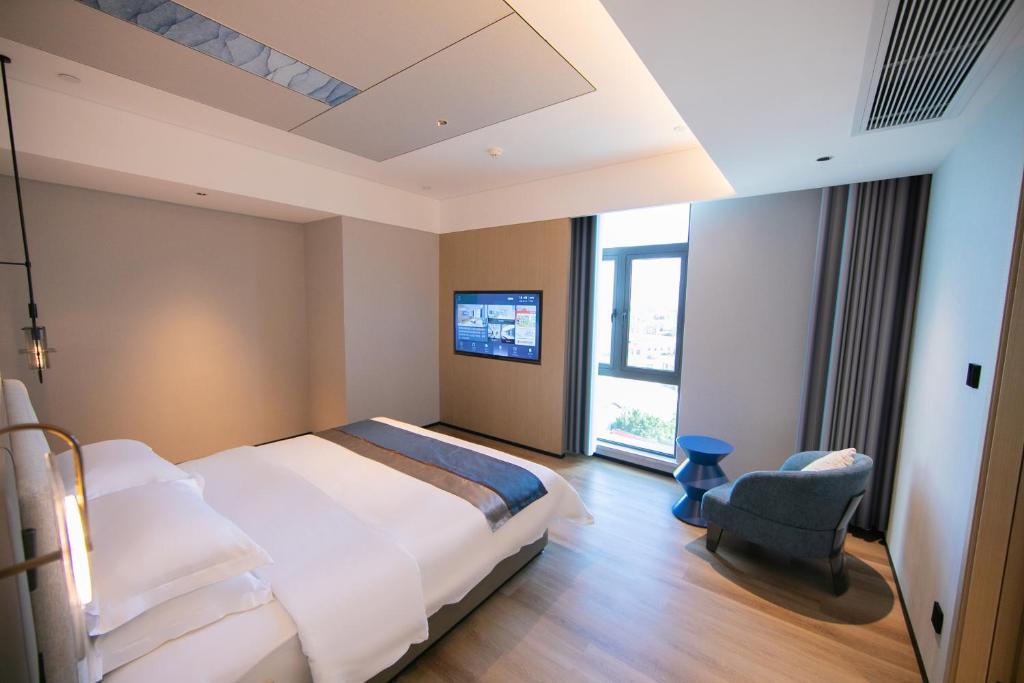 Postel nebo postele na pokoji v ubytování Chaozhou Yuyu Hotel