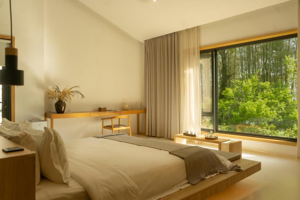 Voodi või voodid majutusasutuse Wangshan Life Diaoxueyuan Design Hotel toas