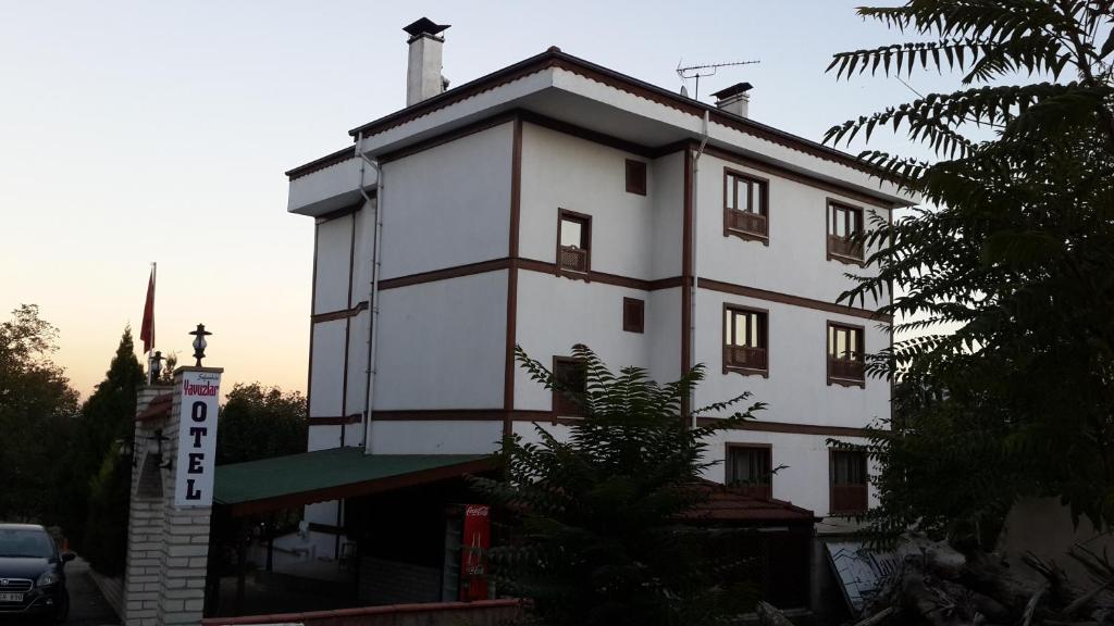 a white building with a cross on top of it at Yavuzlar Hotel in Safranbolu