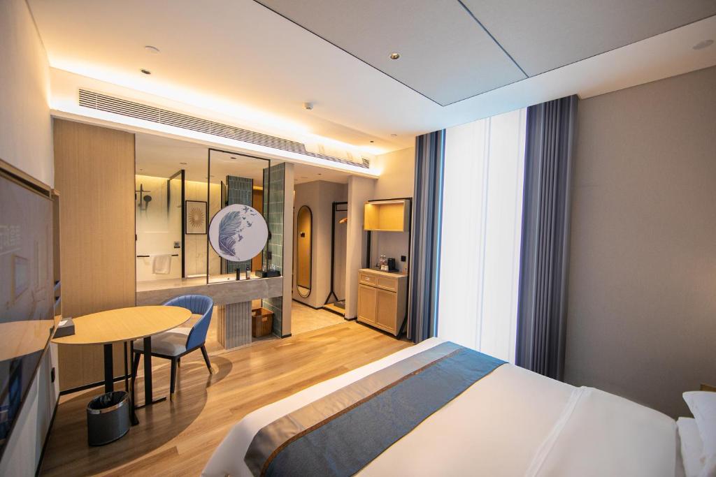 Postel nebo postele na pokoji v ubytování Chaozhou Yuyu Hotel