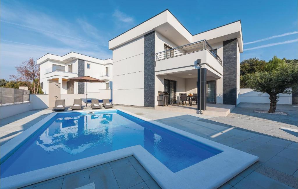 a house with a swimming pool in front of it at Three-Bedroom Holiday Home In Razanj in Ražanj