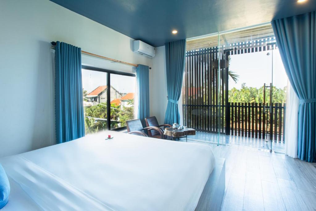 Postel nebo postele na pokoji v ubytování Phúc Villa Hoi An