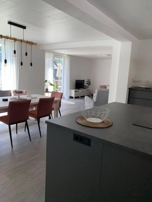 a kitchen and living room with a table and chairs at Ferienwohnung König in Schnaittenbach