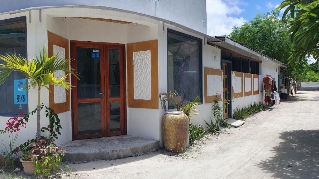 a building with a door on the side of it at Beach Heaven Maldives - Golden Turtle Guest House in Huraa