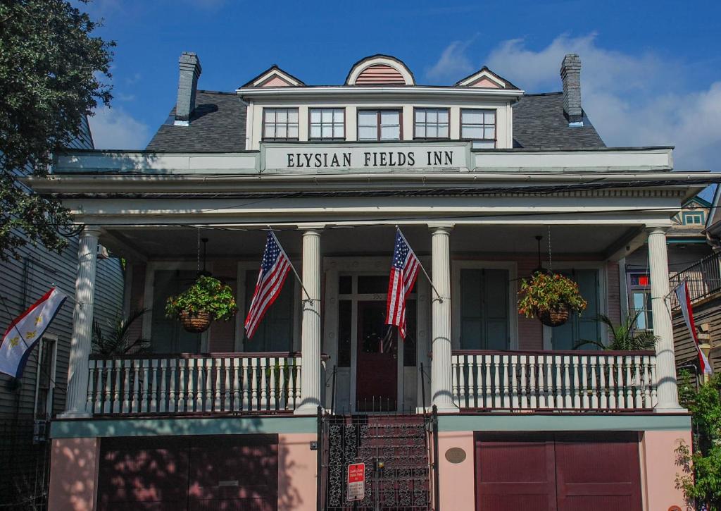 a house with american flags in front of it at Elysian Fields Inn in New Orleans