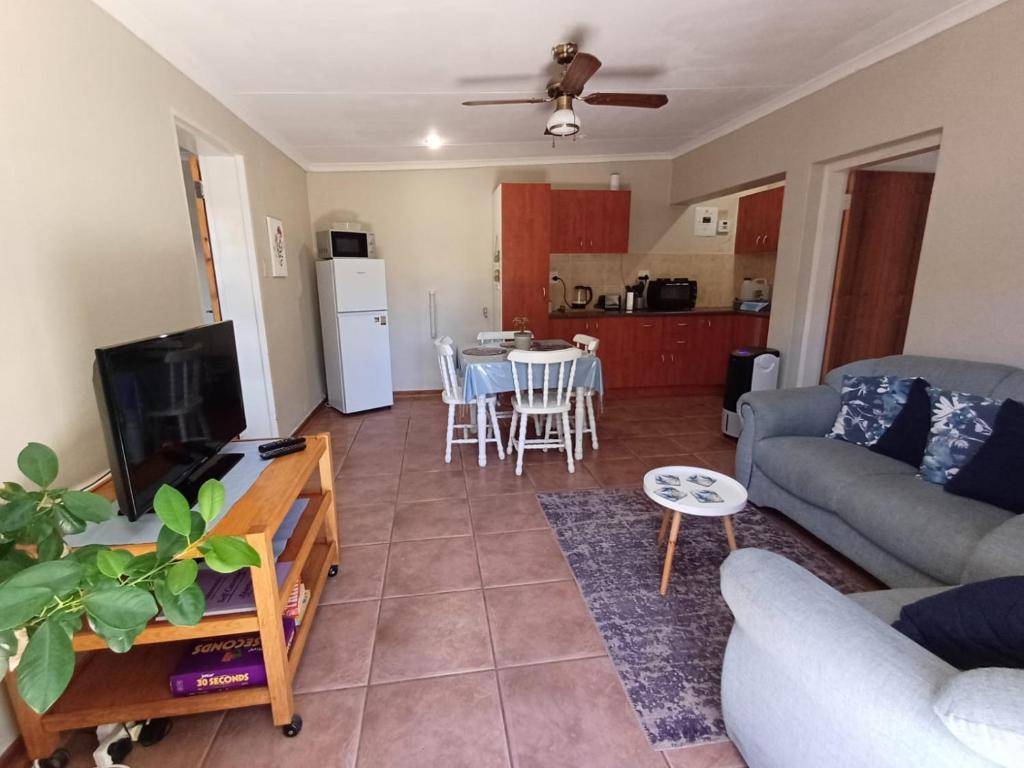 a living room with a couch and a table at Susanna's Self catering 2 bedroom apartment in Kimberley