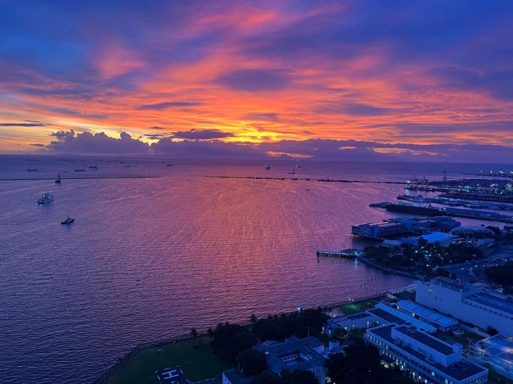 a sunset over a large body of water at Dreamy Sunset Bay in Manila
