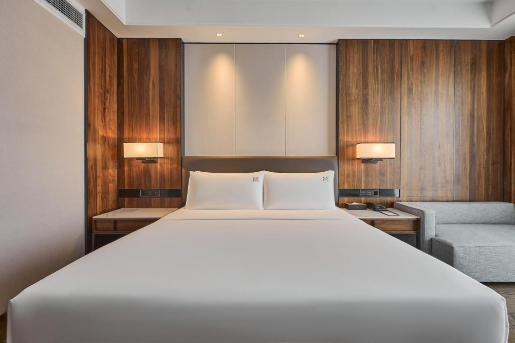 Postel nebo postele na pokoji v ubytování VM Hotel