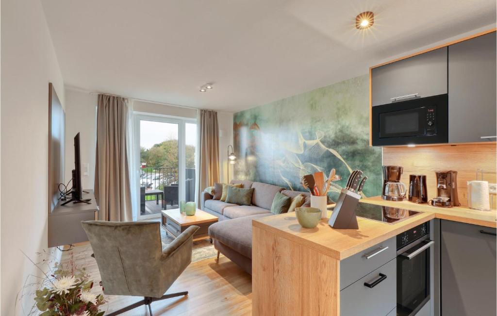 a living room with a couch and a table at 2 Bedroom Cozy Apartment In Nordstrand in Nordstrand