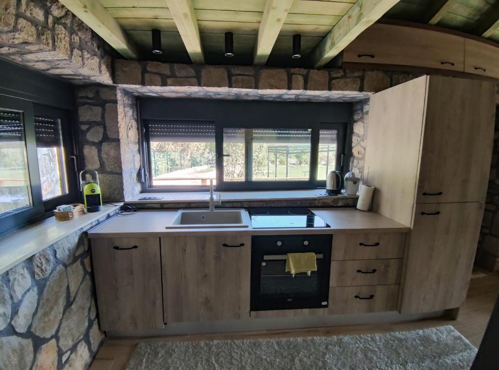 a kitchen with a sink and a stove at Stone House Montenegro in Danilovgrad