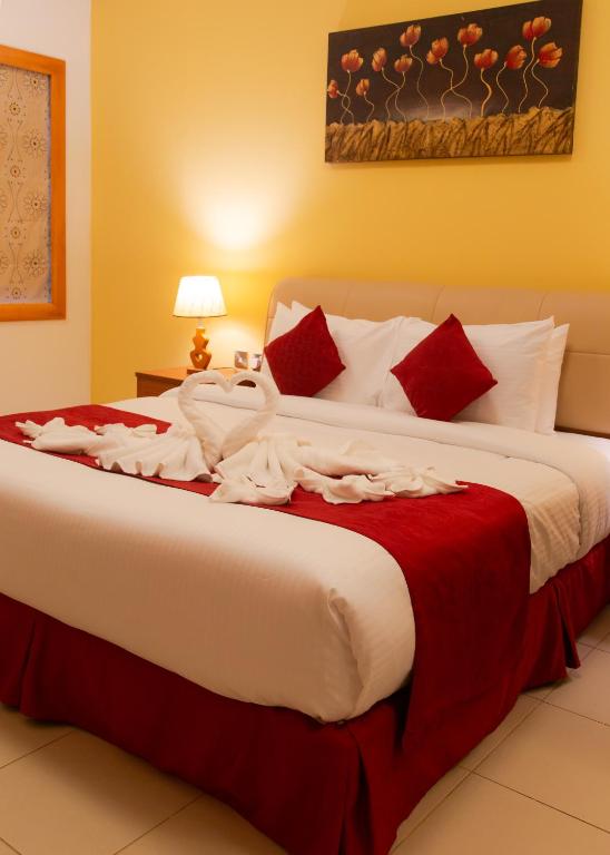 A bed or beds in a room at Al Liwan Residence