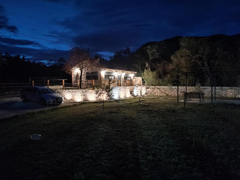 a car parked in front of a house at night at Stone House Montenegro in Danilovgrad