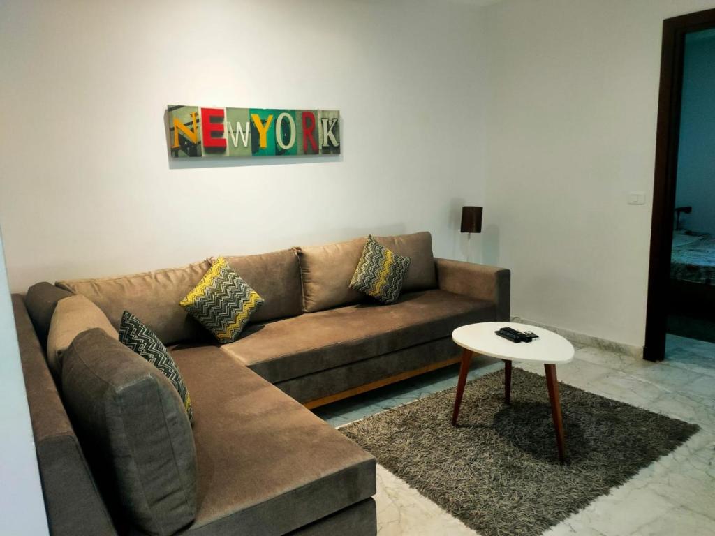 a living room with a couch and a table at luxe & VIP appartement a côté de tunsia mall lac 2 in Tunis