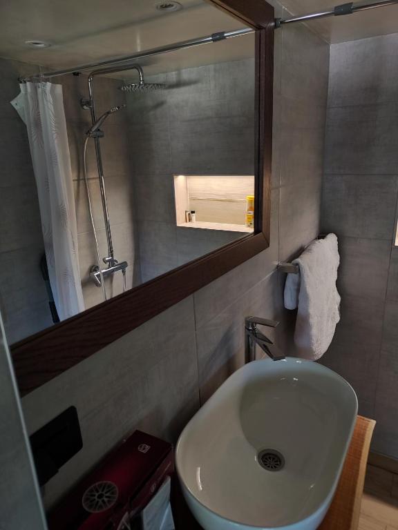 a bathroom with a sink and a mirror at Stone House Montenegro in Danilovgrad