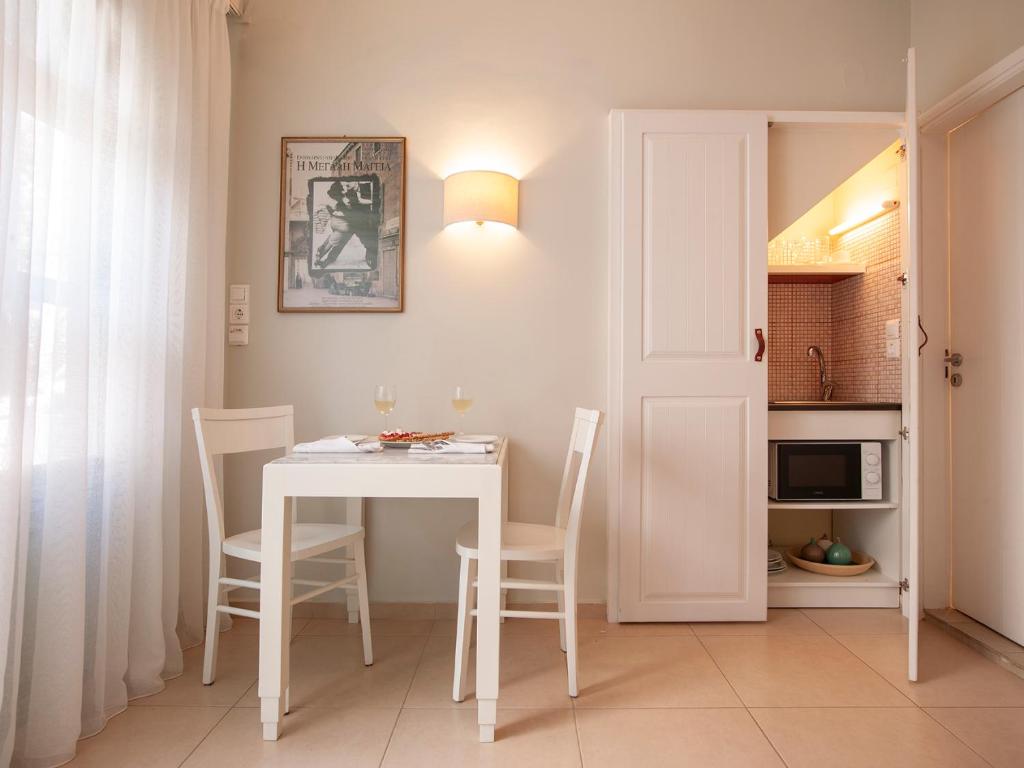 a white table and chairs in a small room at Mythos Suites Boutique Hotel in Rethymno