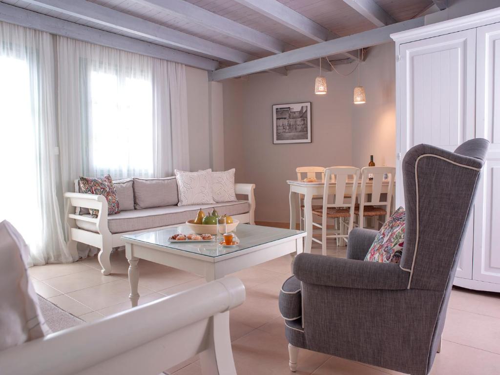 a living room with a couch and a table at Mythos Suites Boutique Hotel in Rethymno