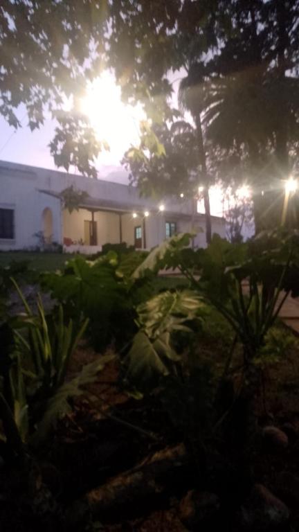 a house with the sun setting in the background at La Casona del Norte Jujuy in San Salvador de Jujuy