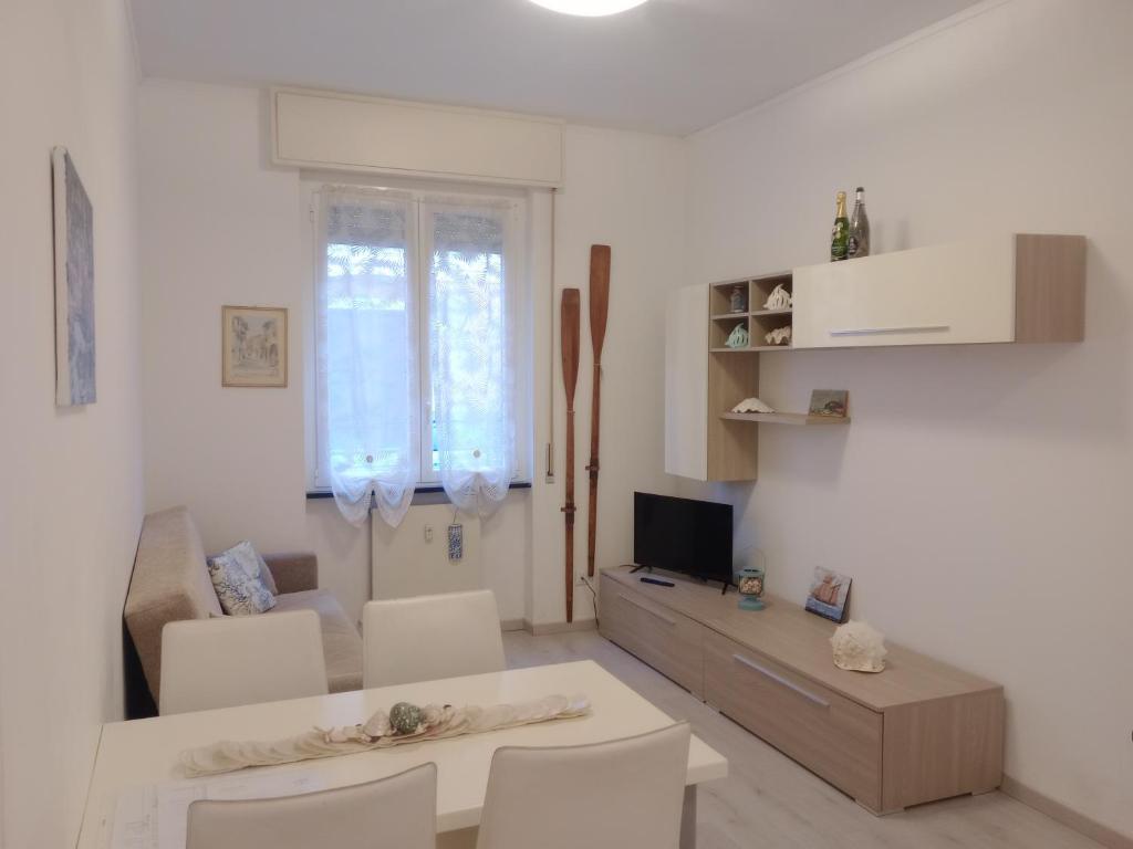 a white living room with a table and chairs at Casa Mariuccia in Santa Margherita Ligure