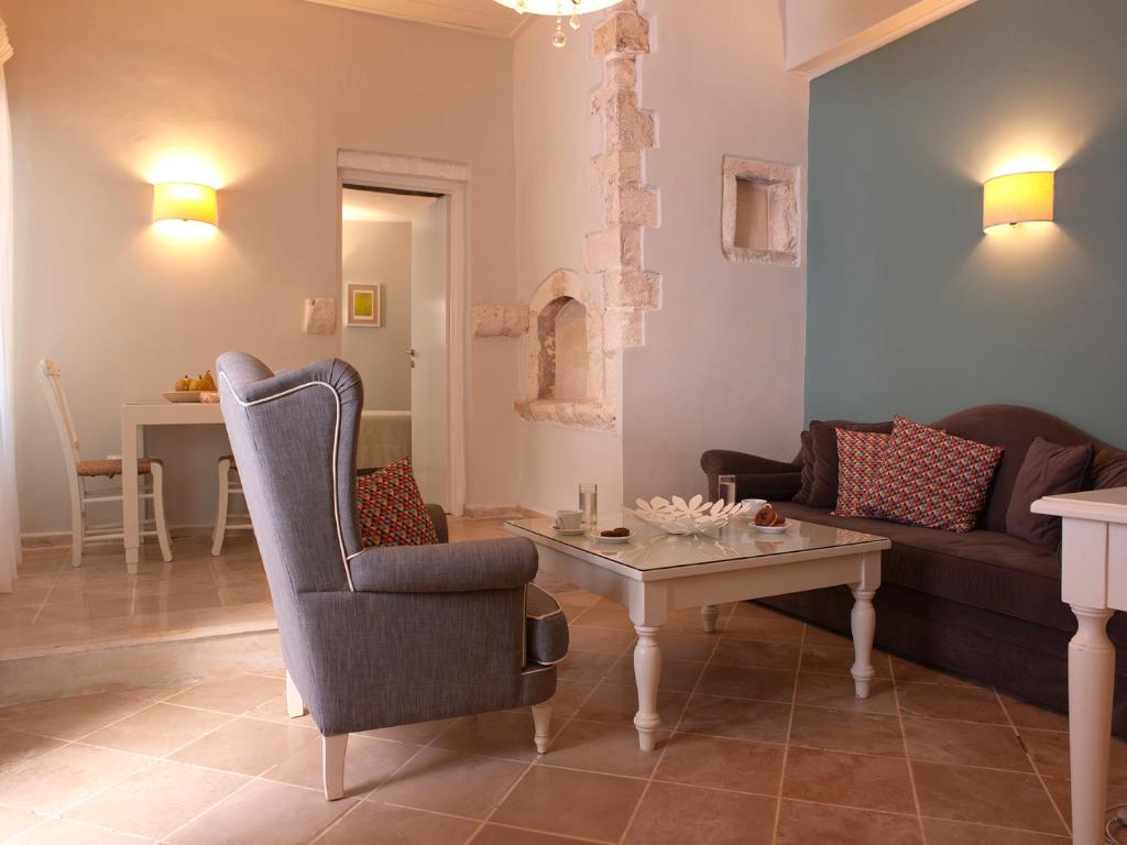 a living room with a couch and a table at Mythos Suites Boutique Hotel in Rethymno