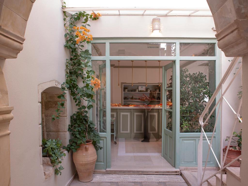 an entrance to a store with flowers in the doorway at Mythos Suites Boutique Hotel in Rethymno