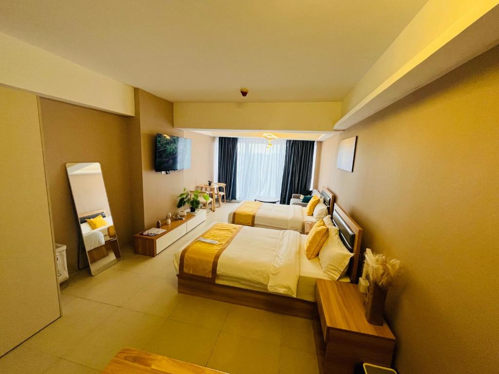 Postel nebo postele na pokoji v ubytování AeonTower Suites&Hotel by CMC