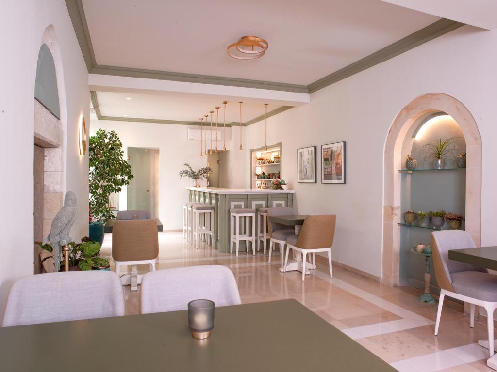 a waiting room with a table and chairs at Mythos Suites Boutique Hotel in Rethymno