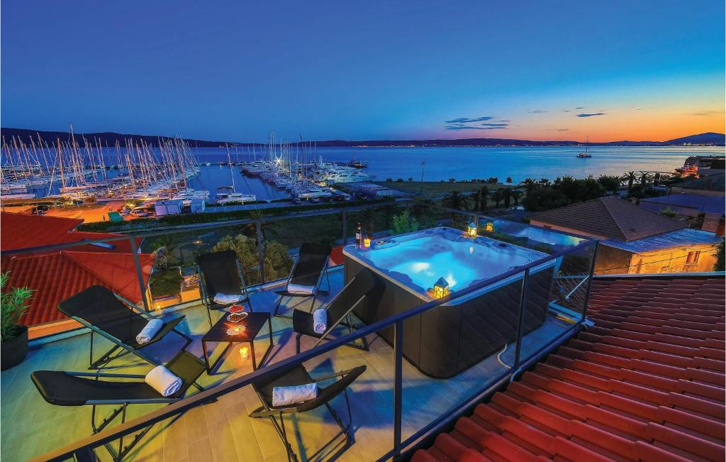 a swimming pool on a balcony with a view of a harbor at Three-Bedroom Apartment In Kastel Gomilica in Kaštela