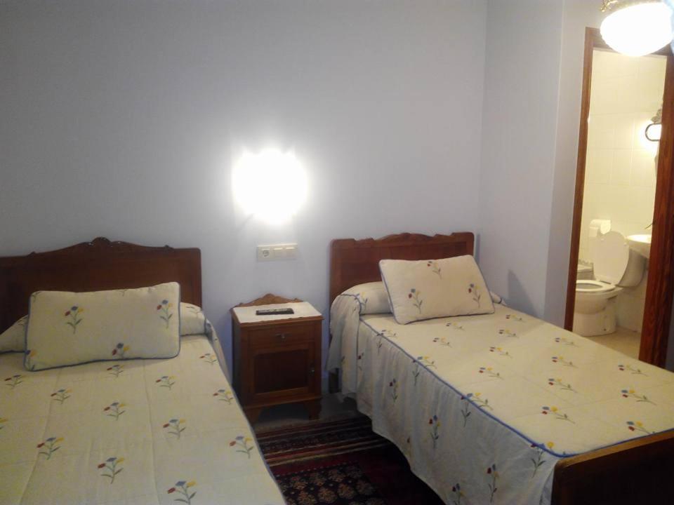 A bed or beds in a room at Hostal Pumar