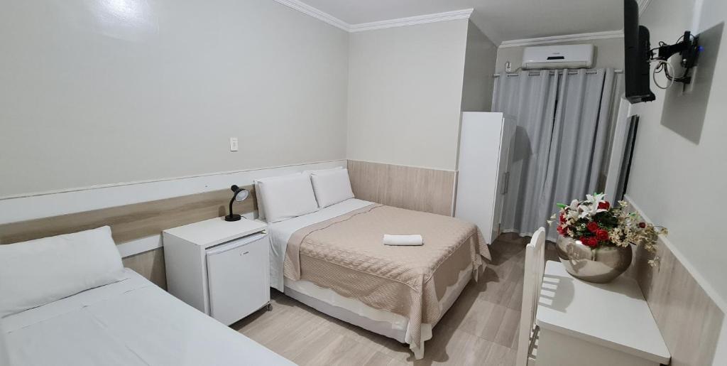 Postel nebo postele na pokoji v ubytování Faixa Hotel