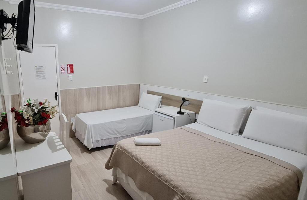 Postel nebo postele na pokoji v ubytování Faixa Hotel