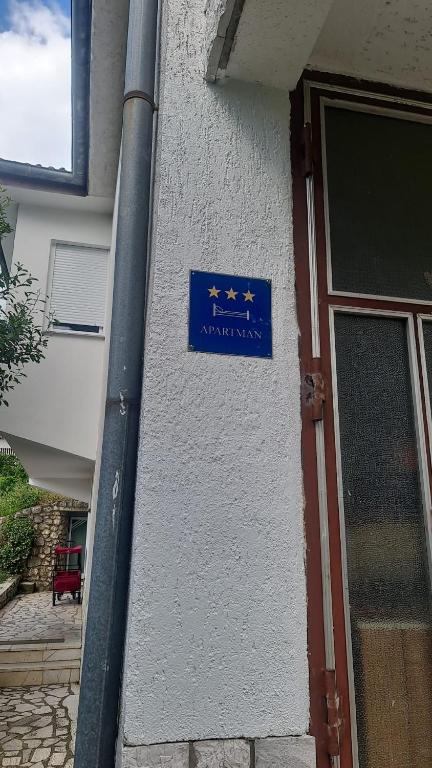 a blue sign on the side of a building at Apartment Anton in Selce