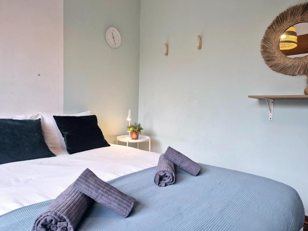 a bedroom with a bed with two towels on it at Casa da Baixa in Faro