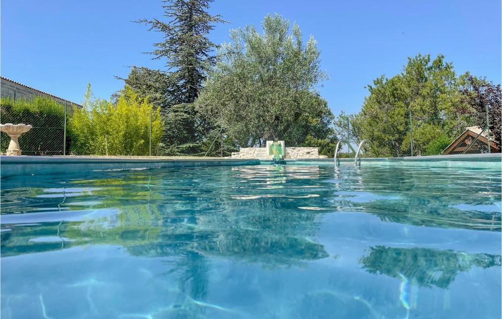a swimming pool with clear blue water at Lovely Home In Villes-Sur-Auzon in Villes-sur-Auzon