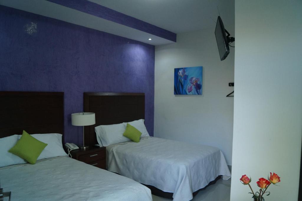 Postel nebo postele na pokoji v ubytování Hotel Casa Palomino