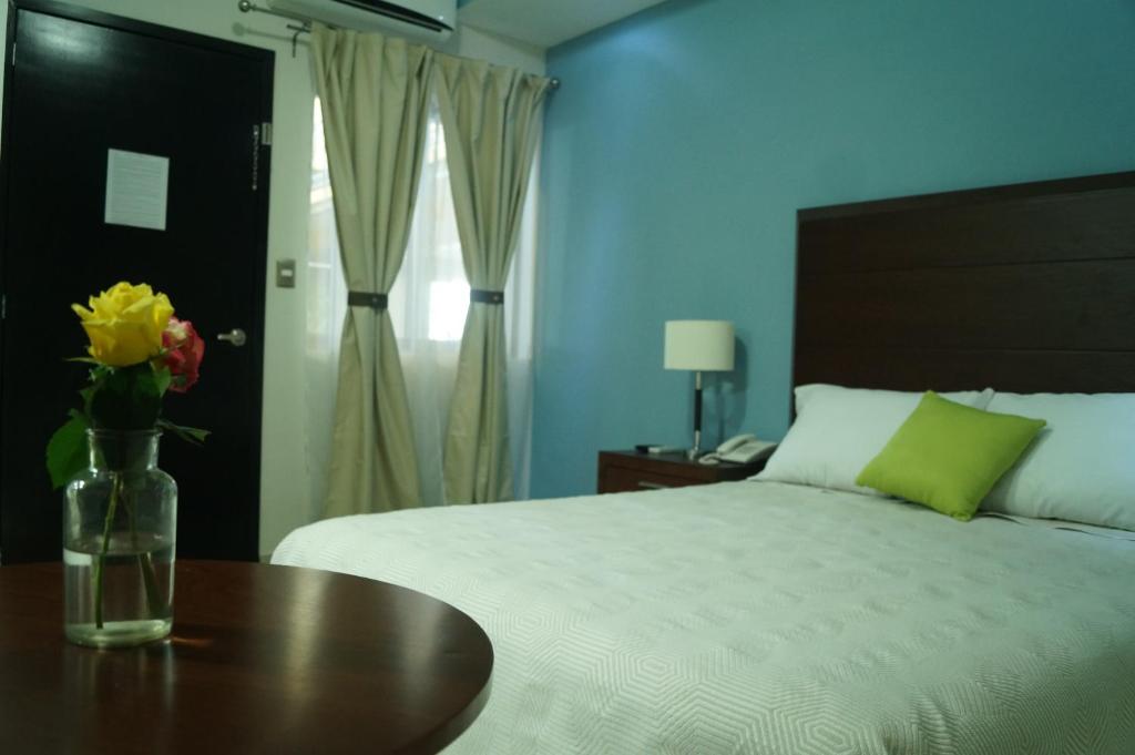 Postel nebo postele na pokoji v ubytování Hotel Casa Palomino