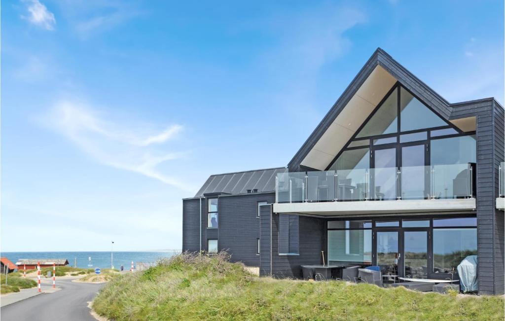 a black house with a view of the ocean at Two-Bedroom Apartment In Thisted in Thisted