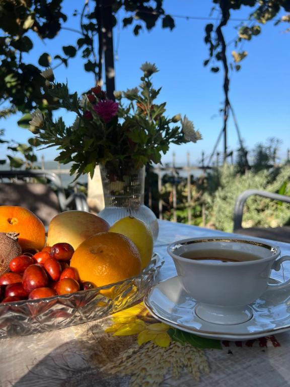 a table with a bowl of fruit and a cup of coffee at Apartmani Gazivode in Budva